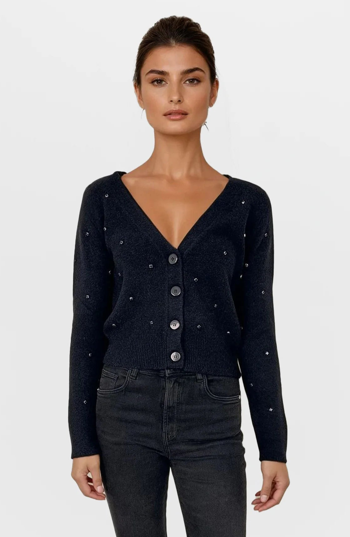 Woman wearing a black cardigan with button details on a white background