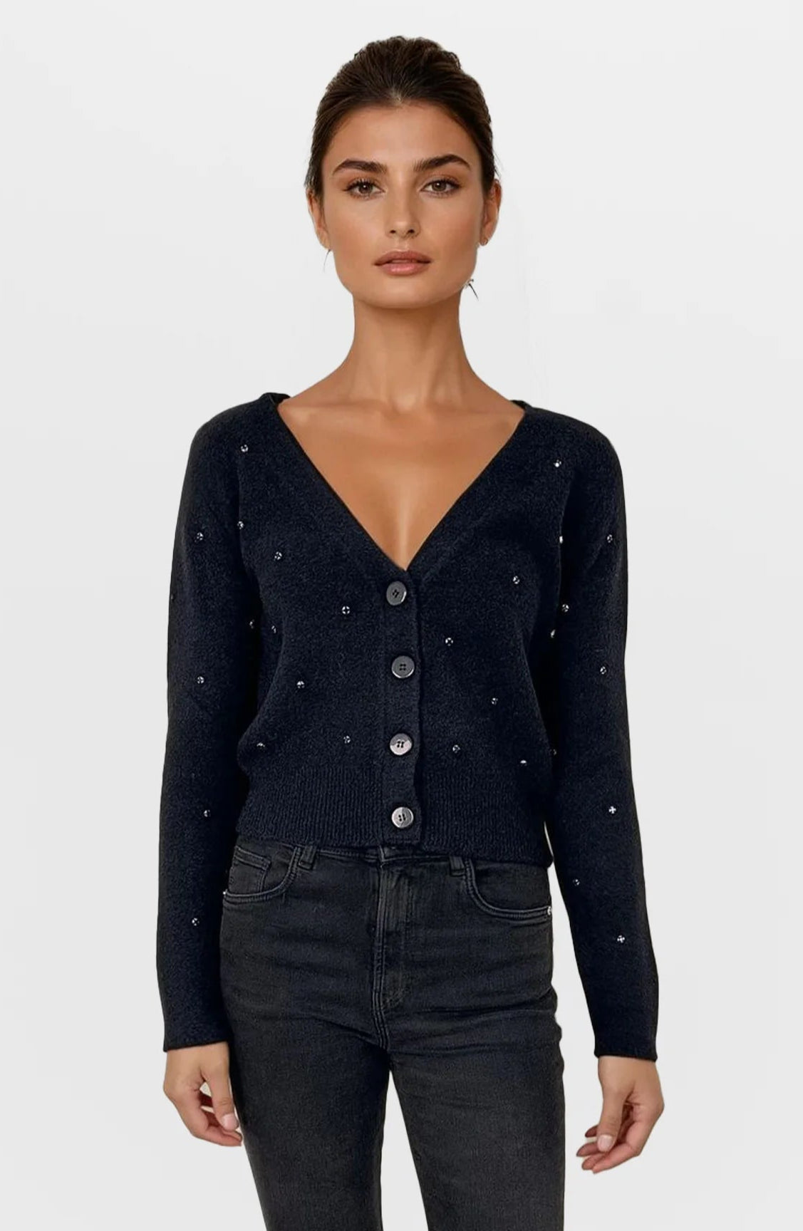 Woman wearing a black cardigan with button details on a white background