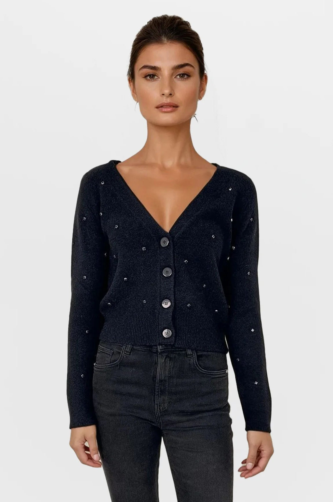 Woman wearing a black cardigan with button details on a white background