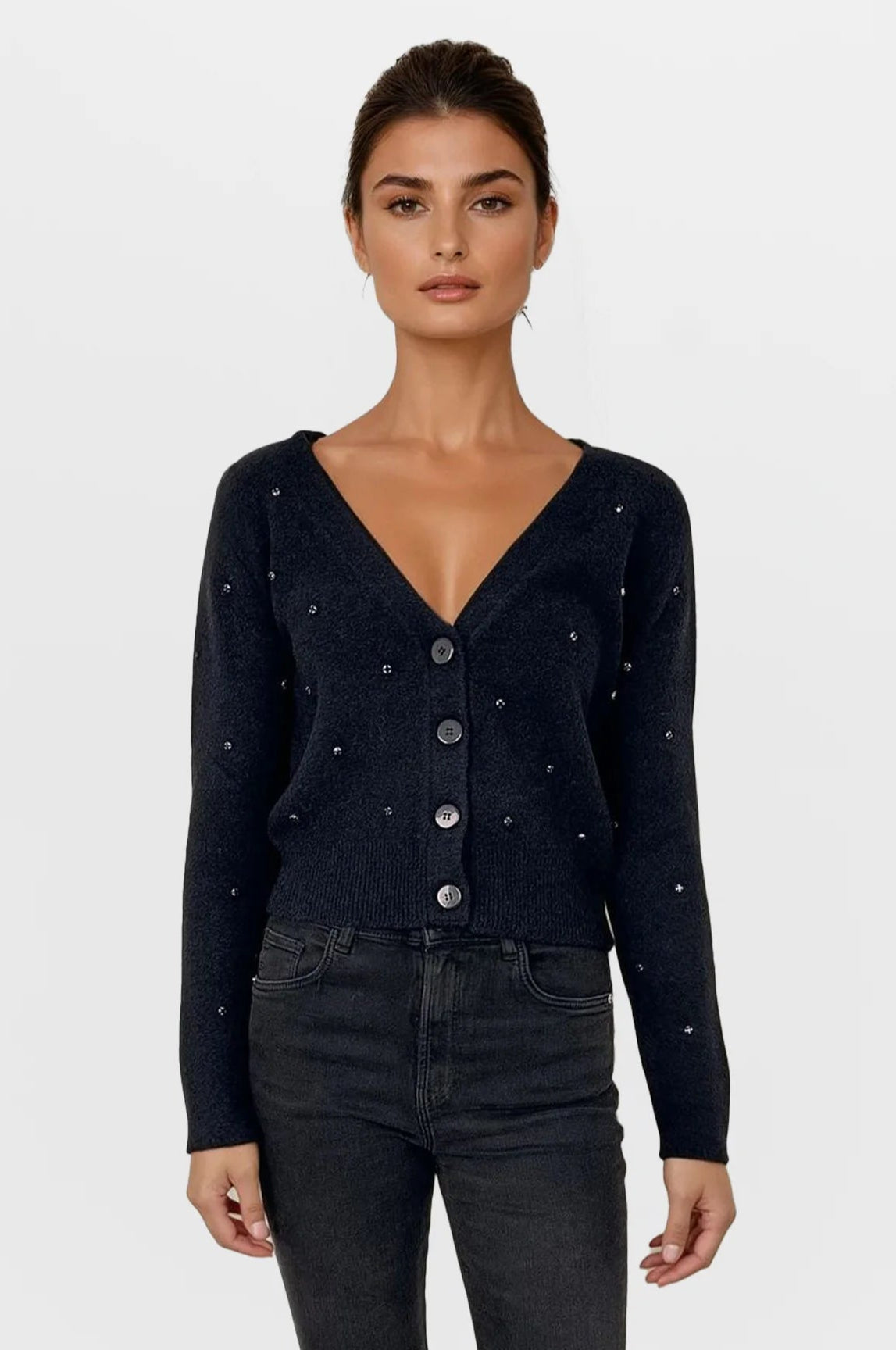 Woman wearing a black cardigan with button details on a white background