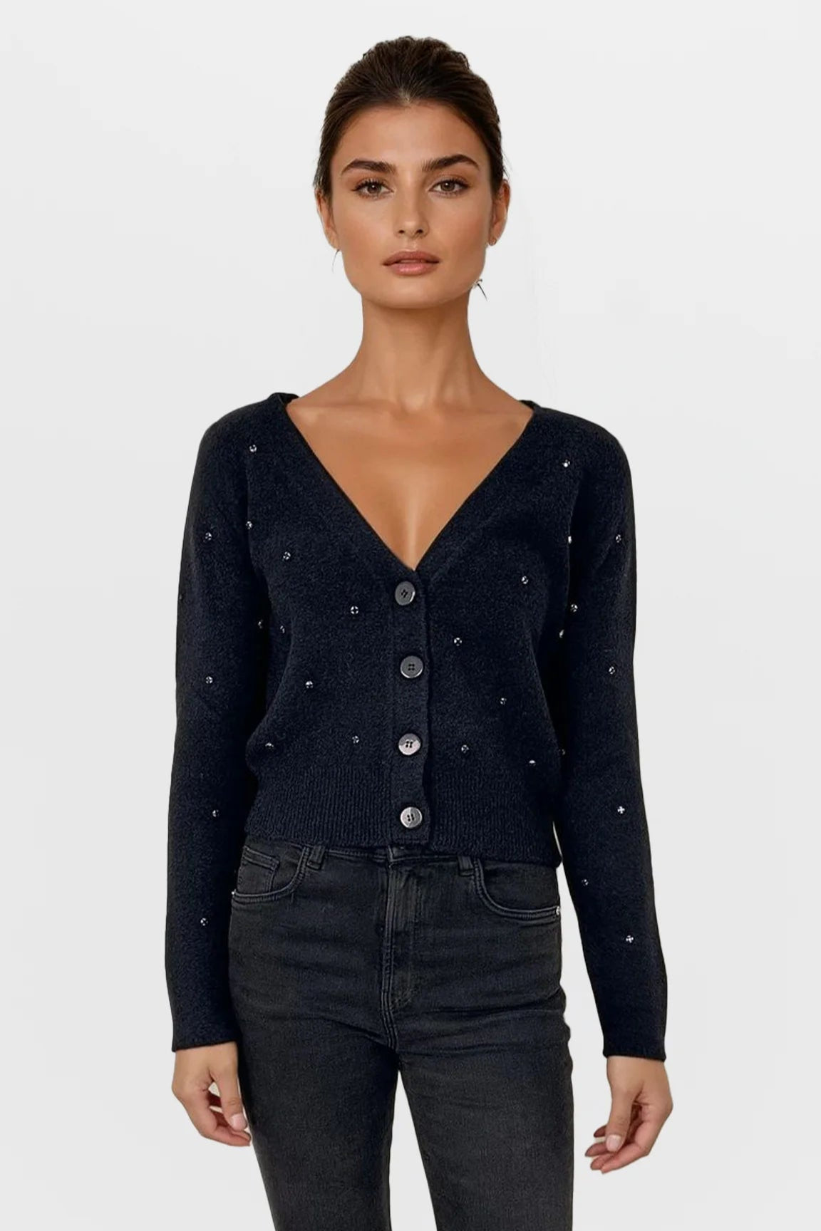 Woman wearing a black cardigan with button details on a white background