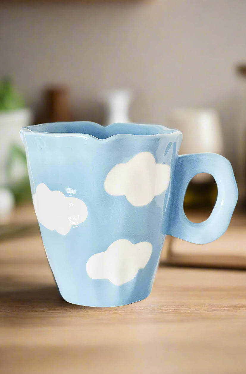 Blue mug with cloud designs on a white background