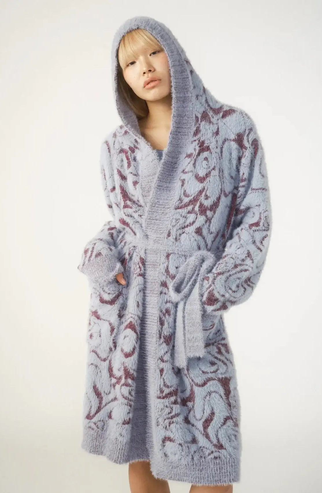 Person wearing a patterned robe on a white background