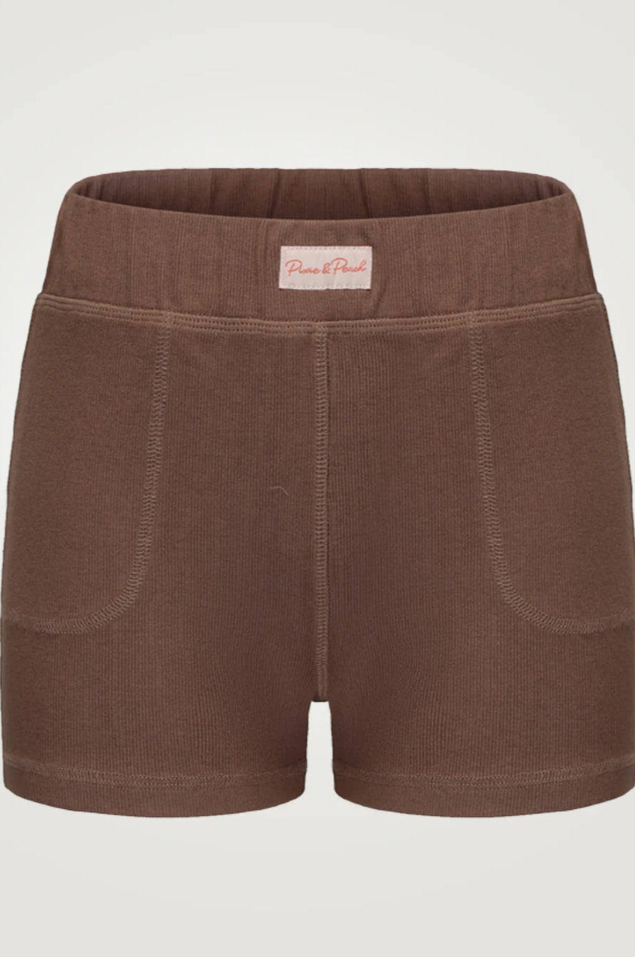 Brown shorts with a visible brand label on a light gray background