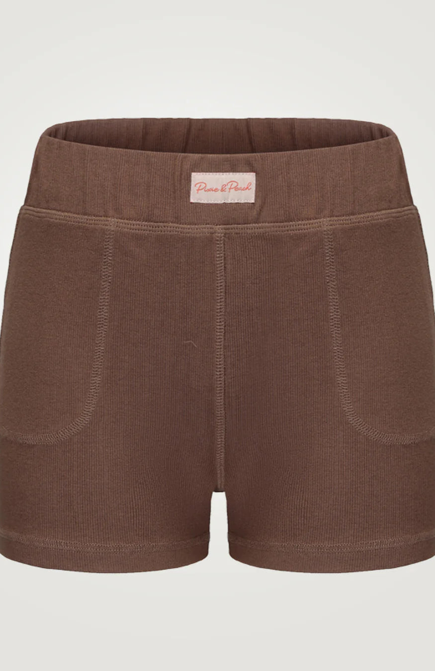 Brown shorts with a visible brand label on a light gray background