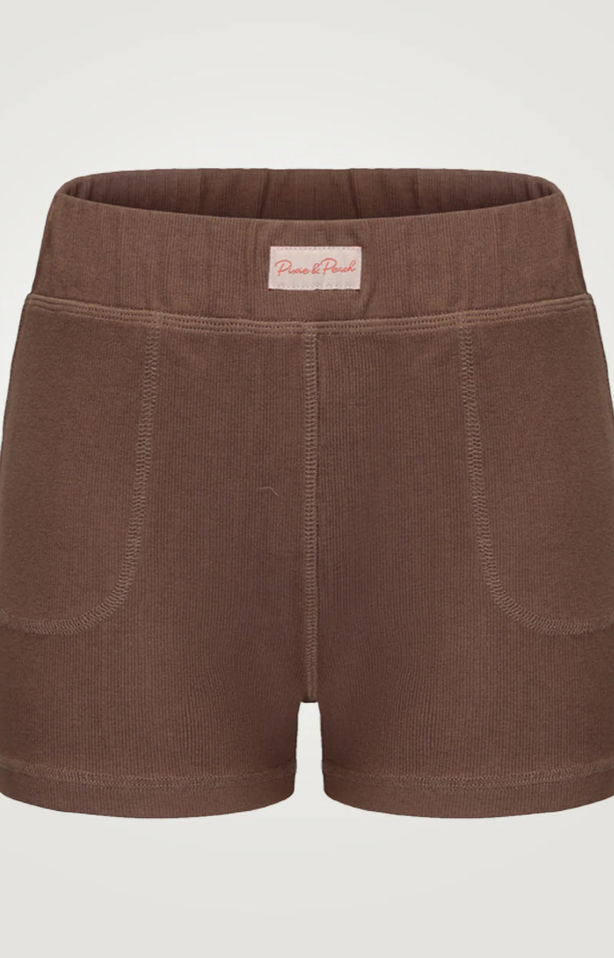 Brown shorts with a visible brand label on a light gray background