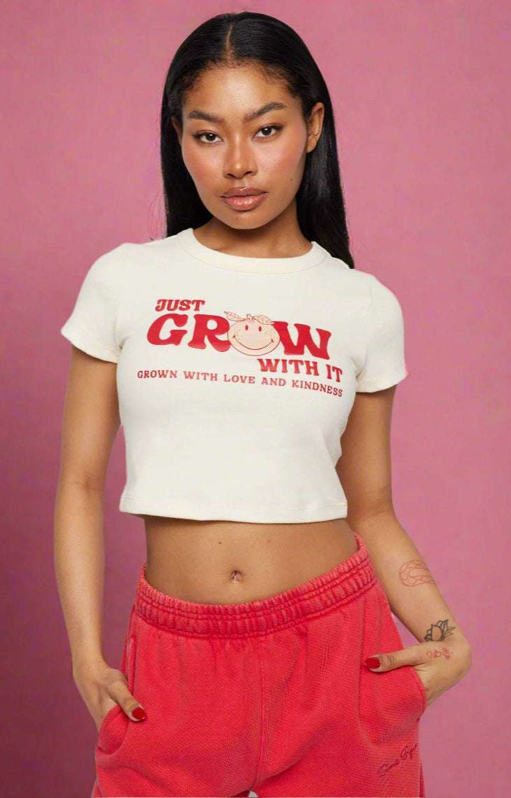 Samii Ryan x Smileyworld® Just Grow With It Baby Tee T-Shirt by Samii Ryan as seen on celebrities