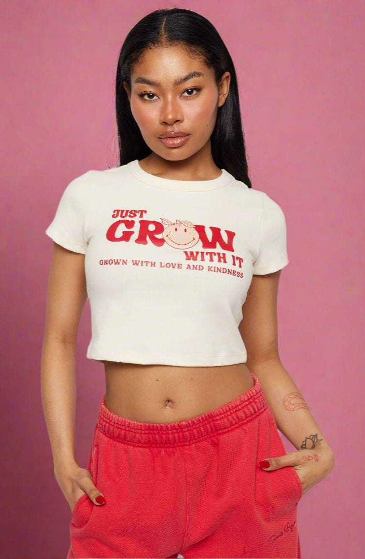 Samii Ryan x Smileyworld® Just Grow With It Baby Tee T-Shirt by Samii Ryan as seen on celebrities