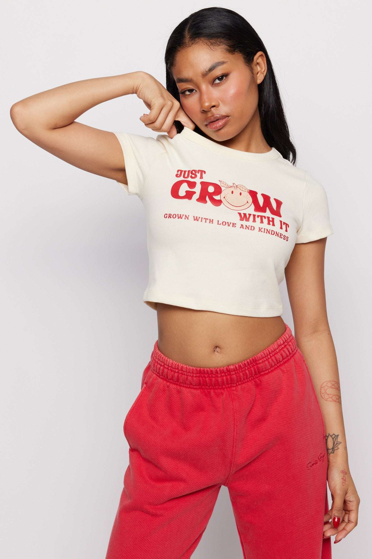 Samii Ryan x Smileyworld® Just Grow With It Baby Tee T-Shirt by Samii Ryan as seen on celebrities