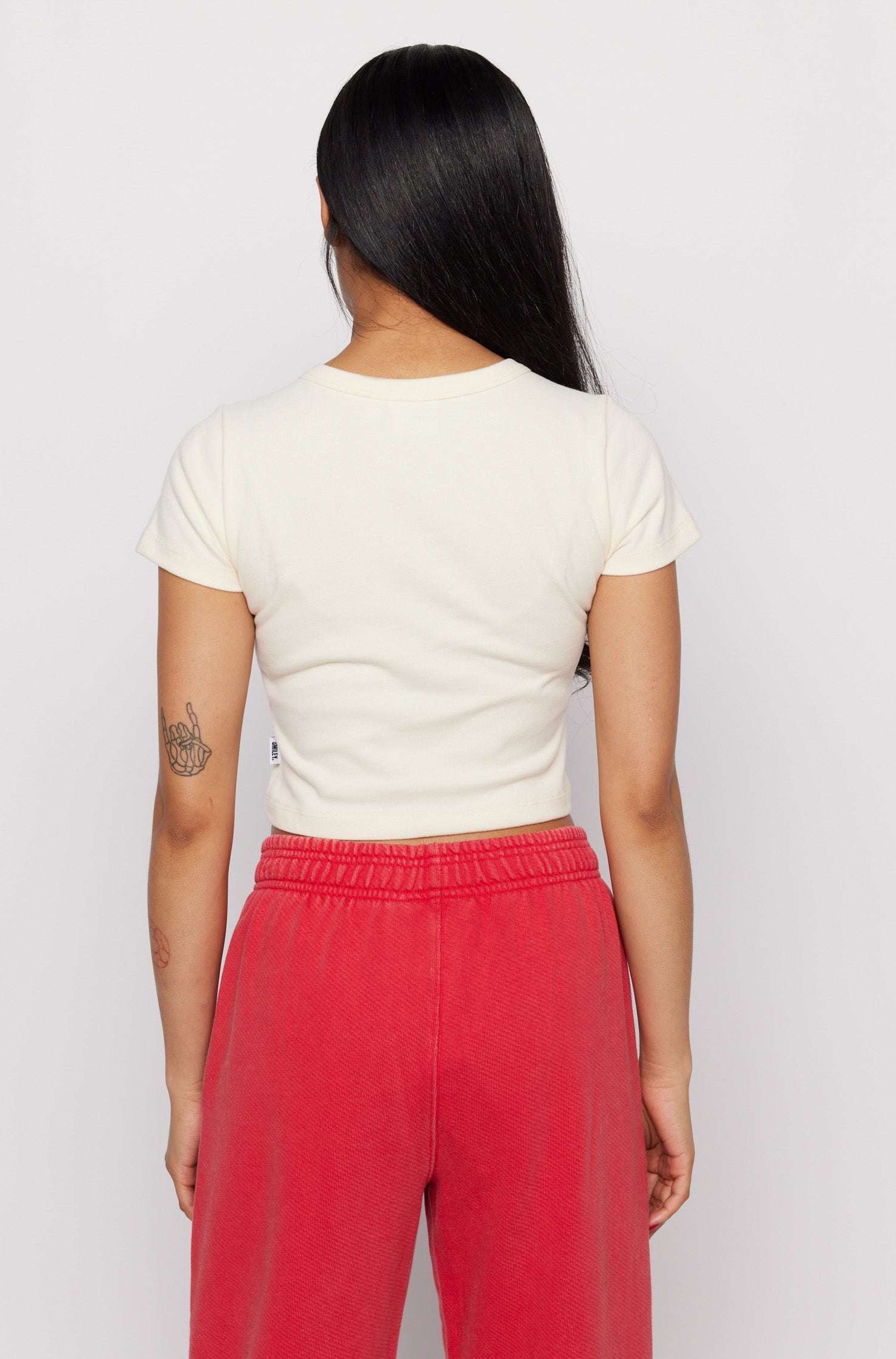 Samii Ryan x Smileyworld® Just Grow With It Baby Tee T-Shirt by Samii Ryan as seen on celebrities