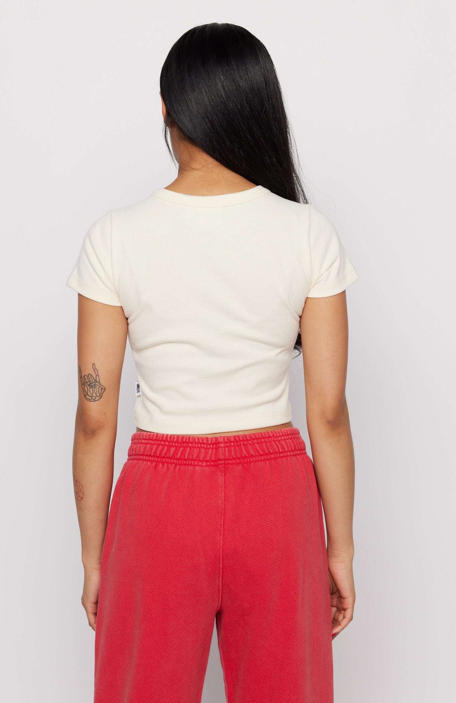 Samii Ryan x Smileyworld® Just Grow With It Baby Tee T-Shirt by Samii Ryan as seen on celebrities