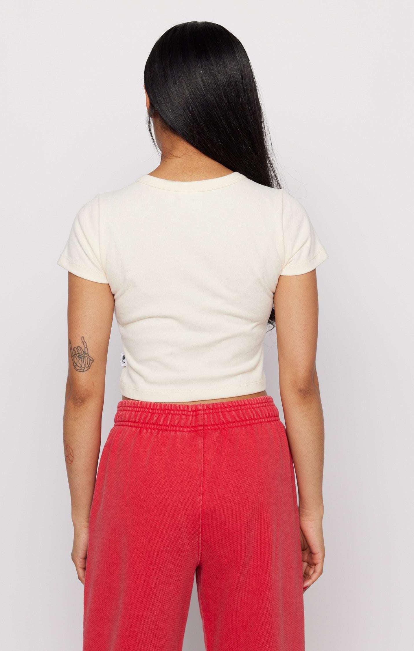 Samii Ryan x Smileyworld® Just Grow With It Baby Tee T-Shirt by Samii Ryan as seen on celebrities