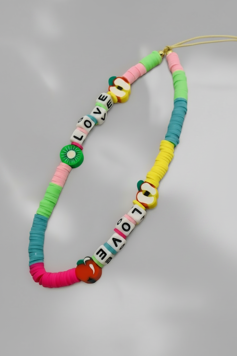 Colorful beaded phone lanyard with 'LOVE' beads on a pink background