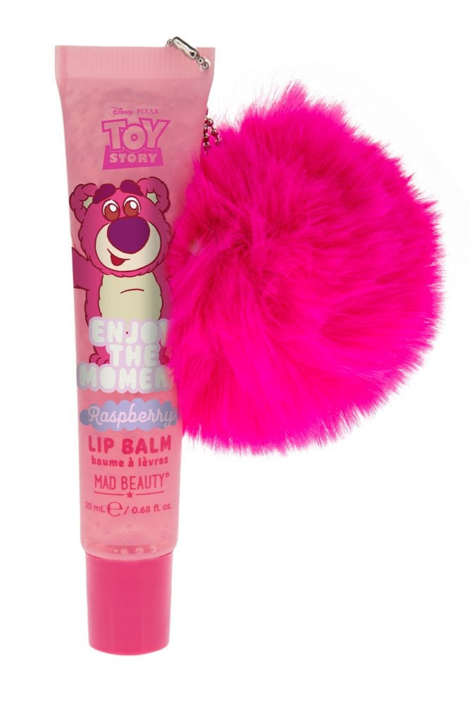 Pink lip balm with a fluffy pink accessory on a white background