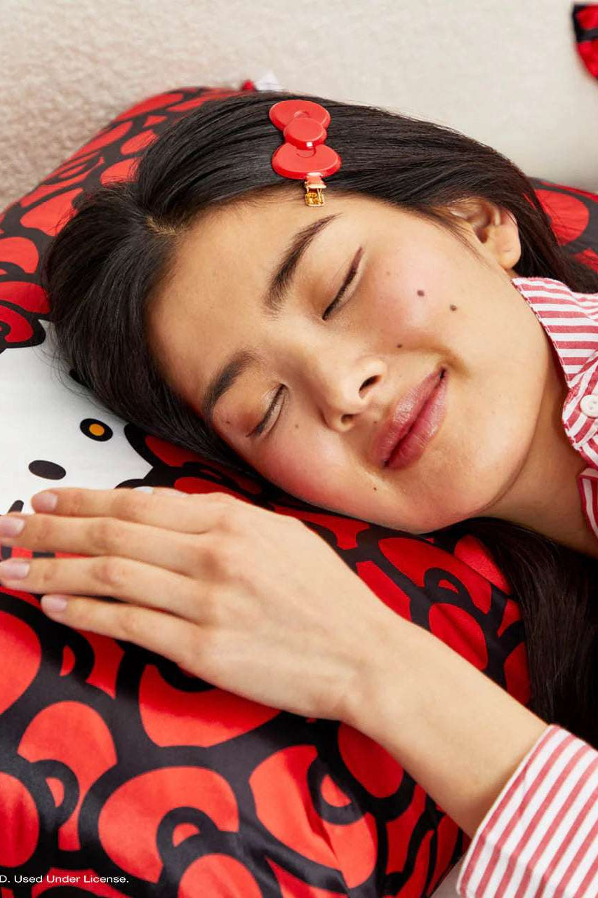 Shop Kitsch Hello Kitty x Kitsch Satin Pillowcase - Hello Kitty Bathes in a Sea of Bows Pillow for women – premium loungewear and festival fashion at Spoiled Brat