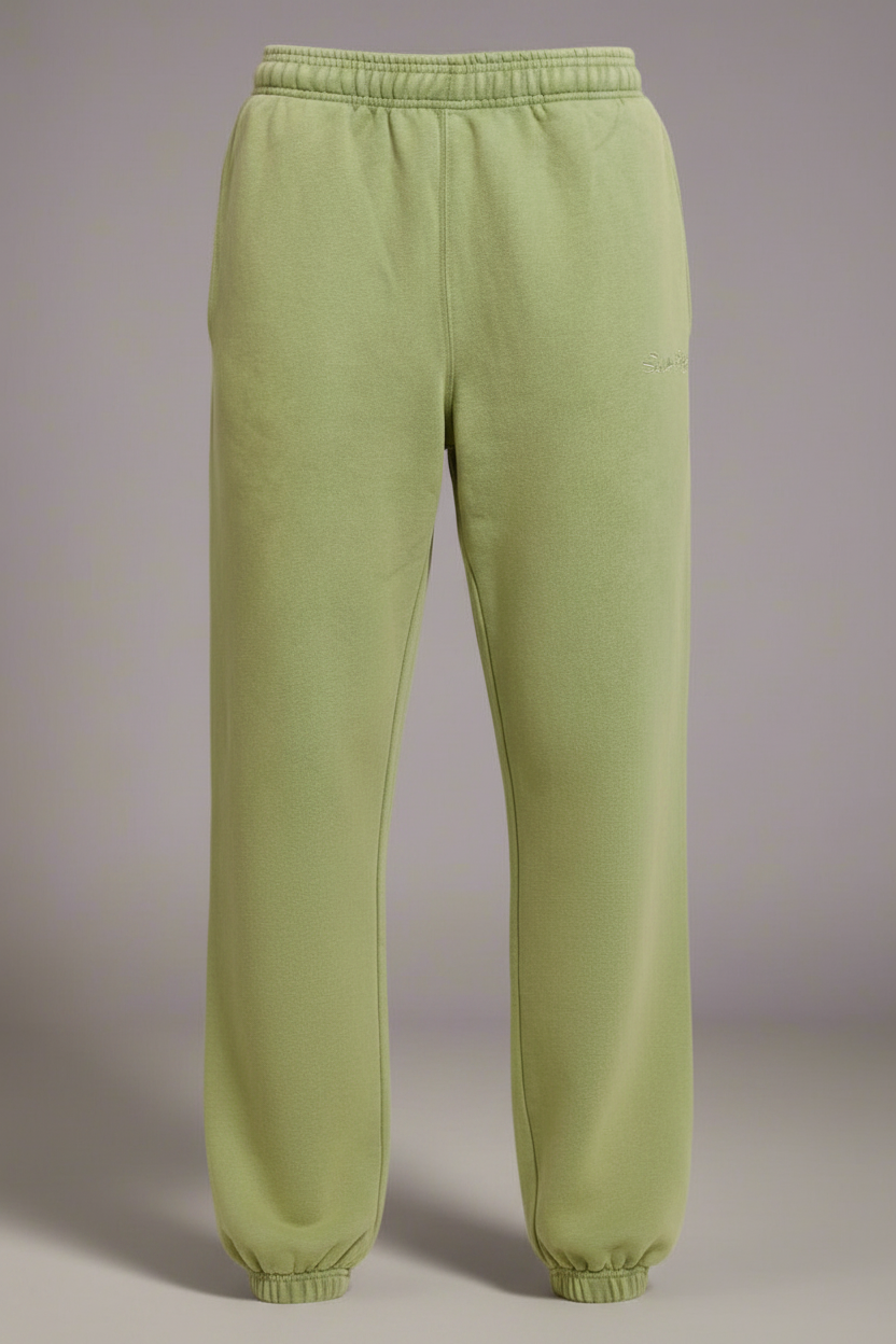 Light green sweatpants on a plain background