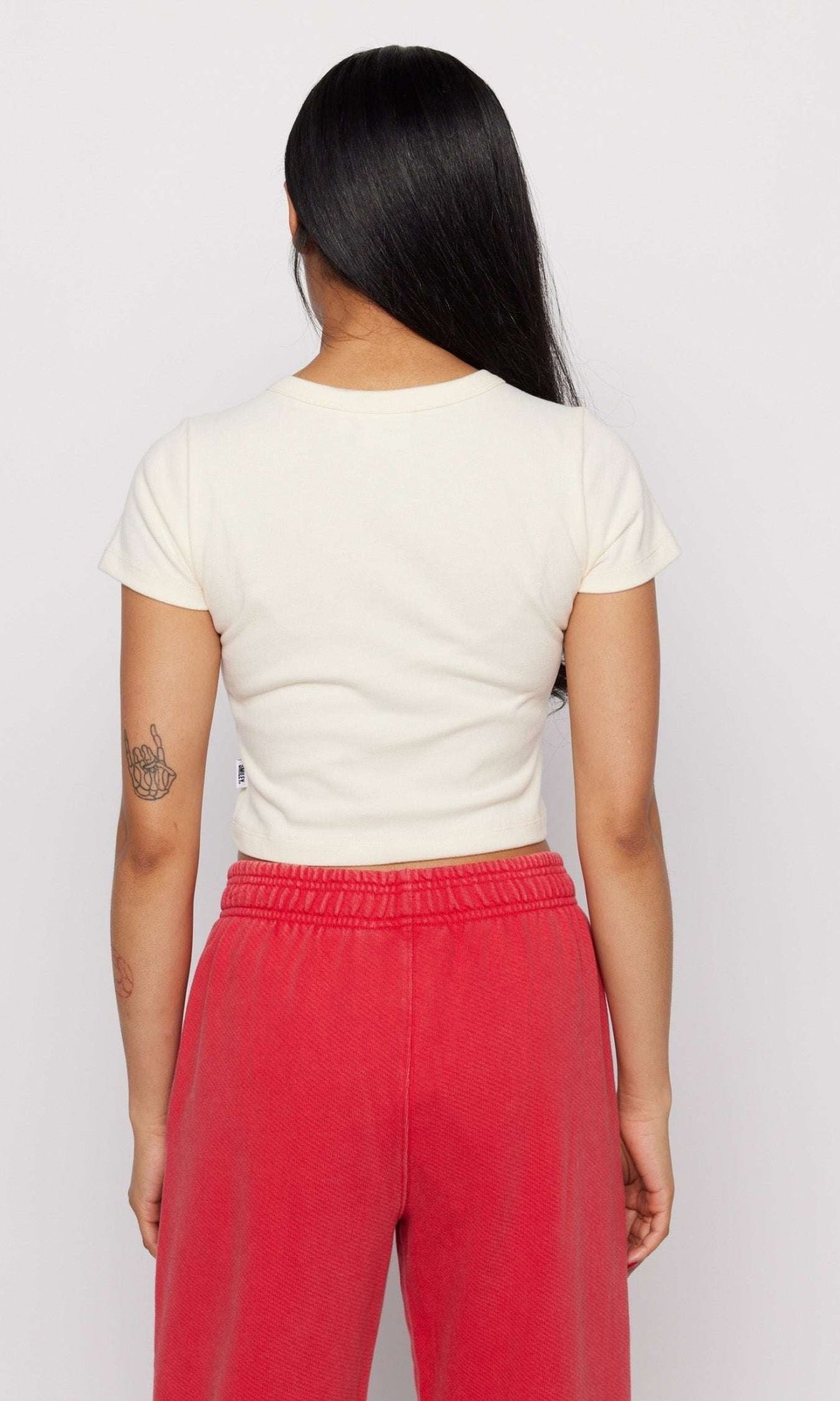 Shop Samii Ryan Samii Ryan x Smileyworld® Just Grow With It Baby Tee T-Shirt for women – premium loungewear and festival fashion at Spoiled Brat