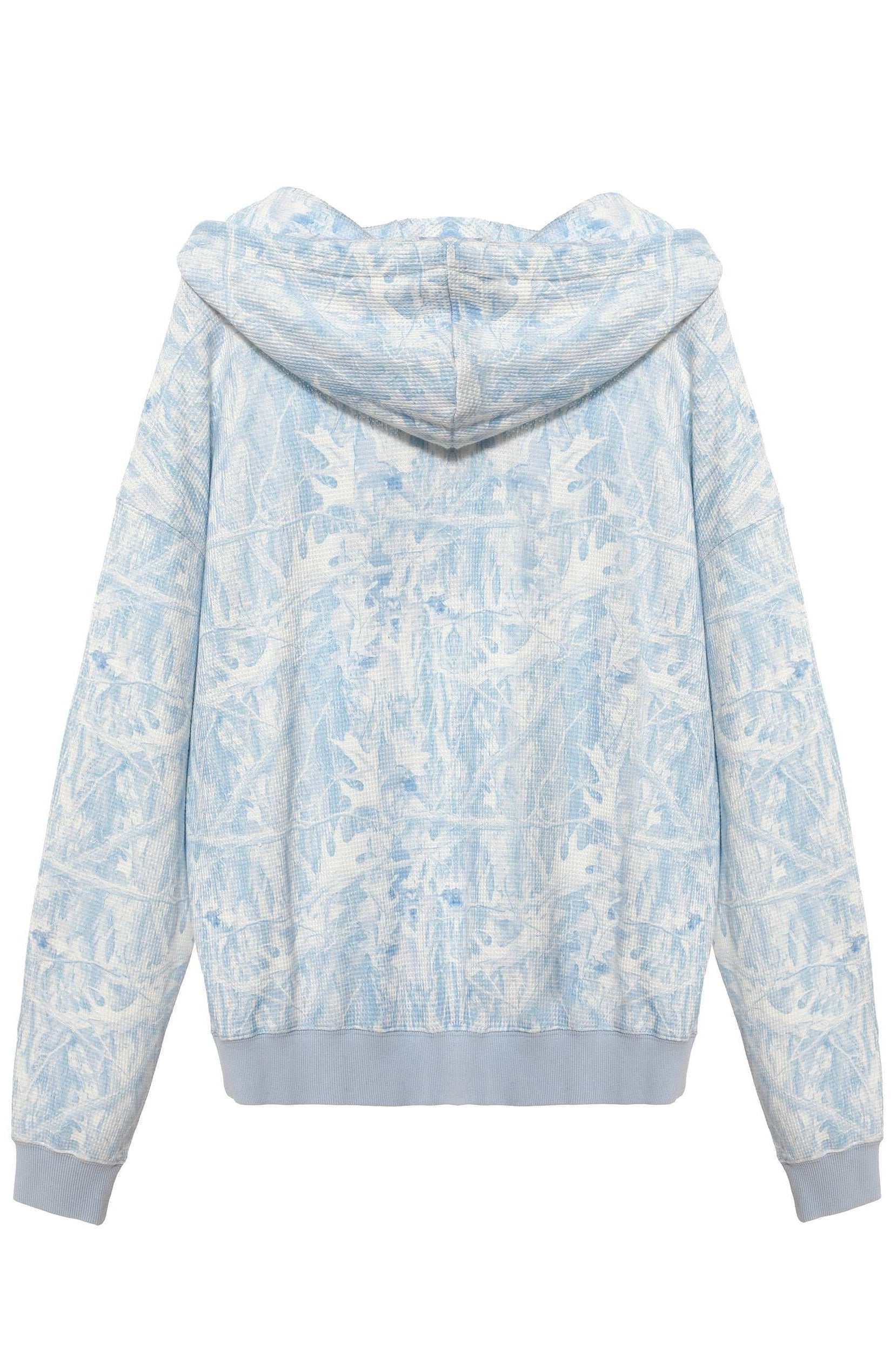 Light blue and white floral patterned hoodie on a white background