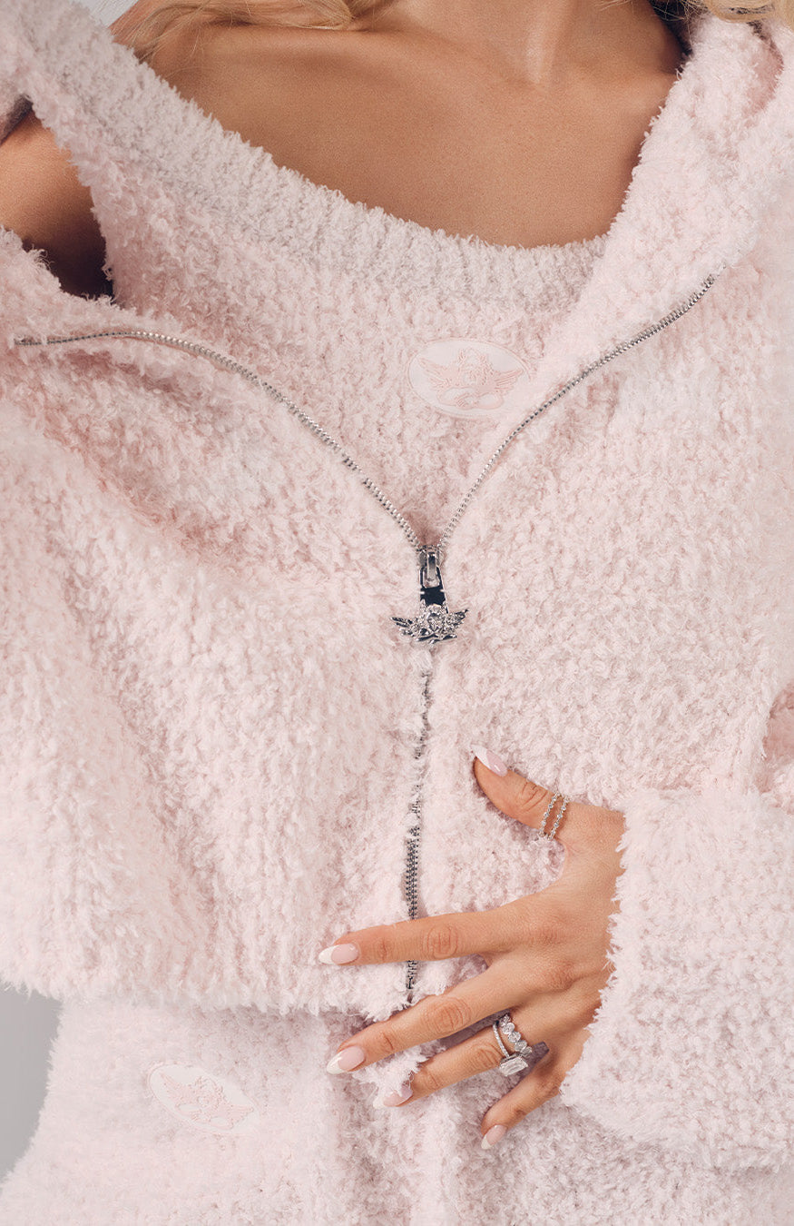 Close-up of a person wearing a fluffy white coat with a blurred background