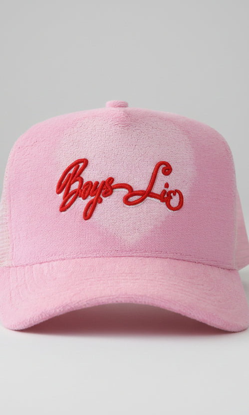 Pink cap with red embroidered text on a white background