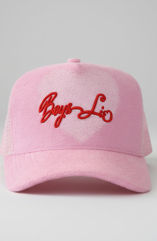 Pink cap with red embroidered text on a white background