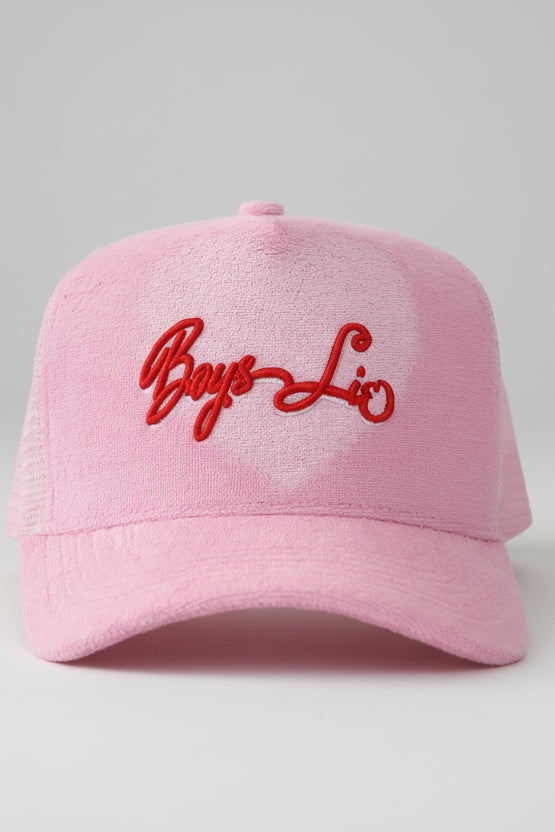 Pink cap with red embroidered text on a white background