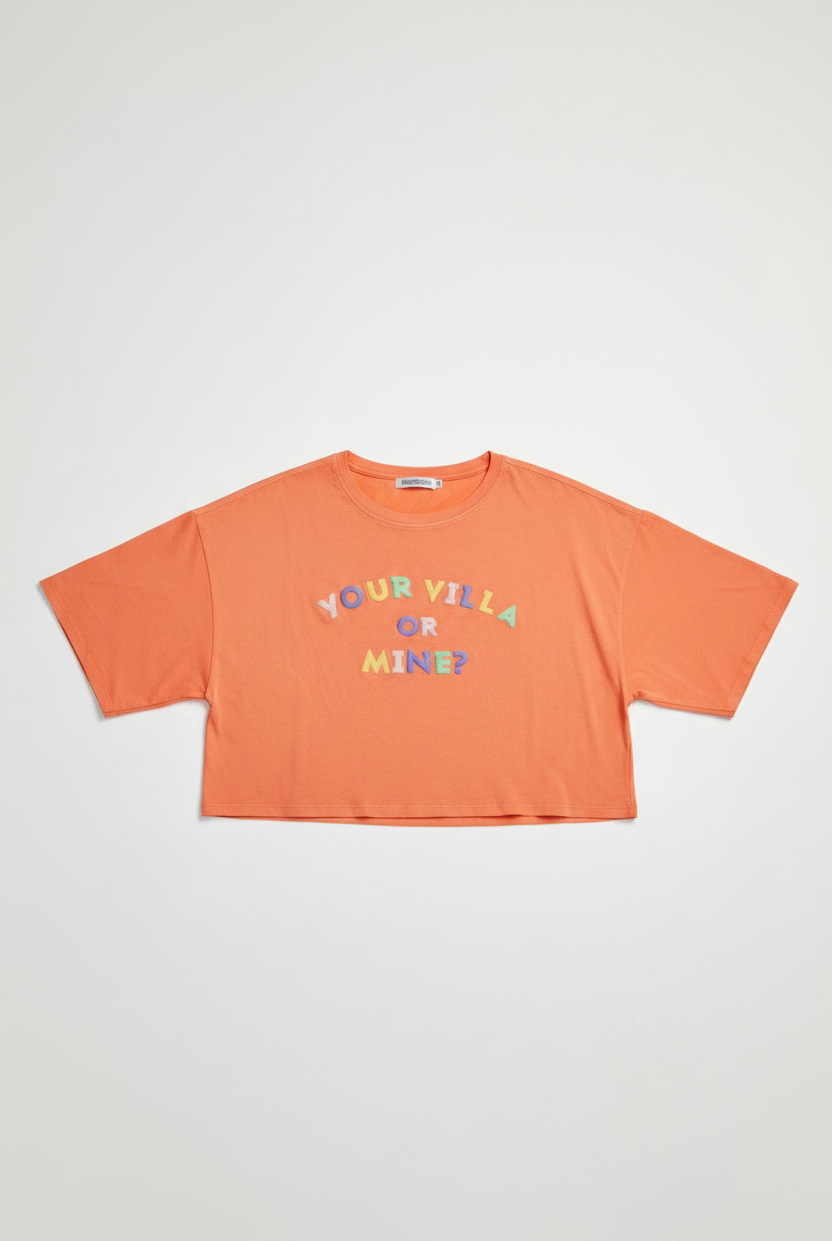 Orange crop top with colorful text on a white background