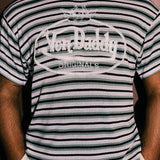 Person wearing a striped t-shirt with 'Von Daddy Originals' logo against a plain background