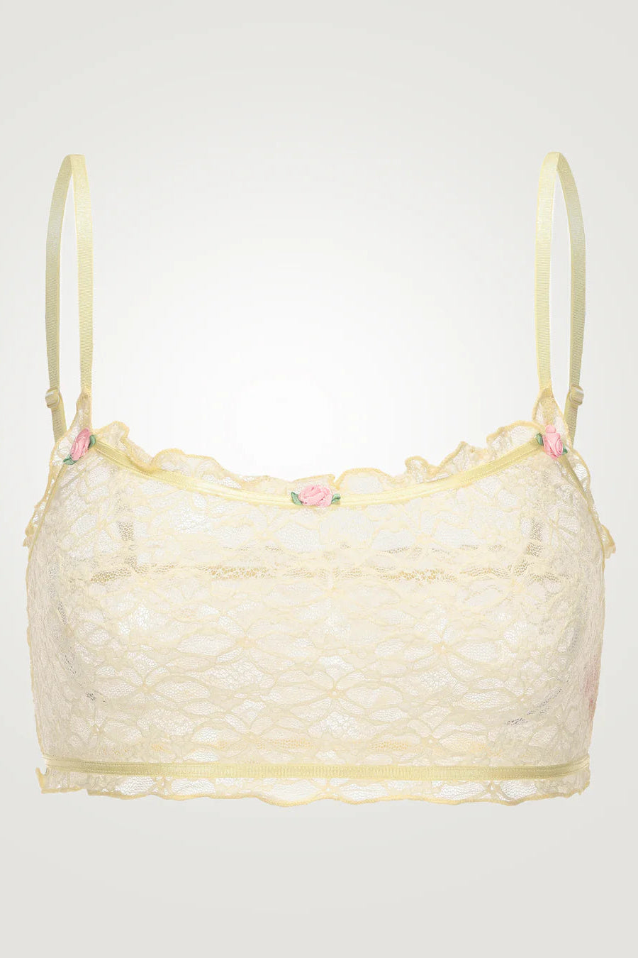Light yellow lace bralette with floral details on a white background