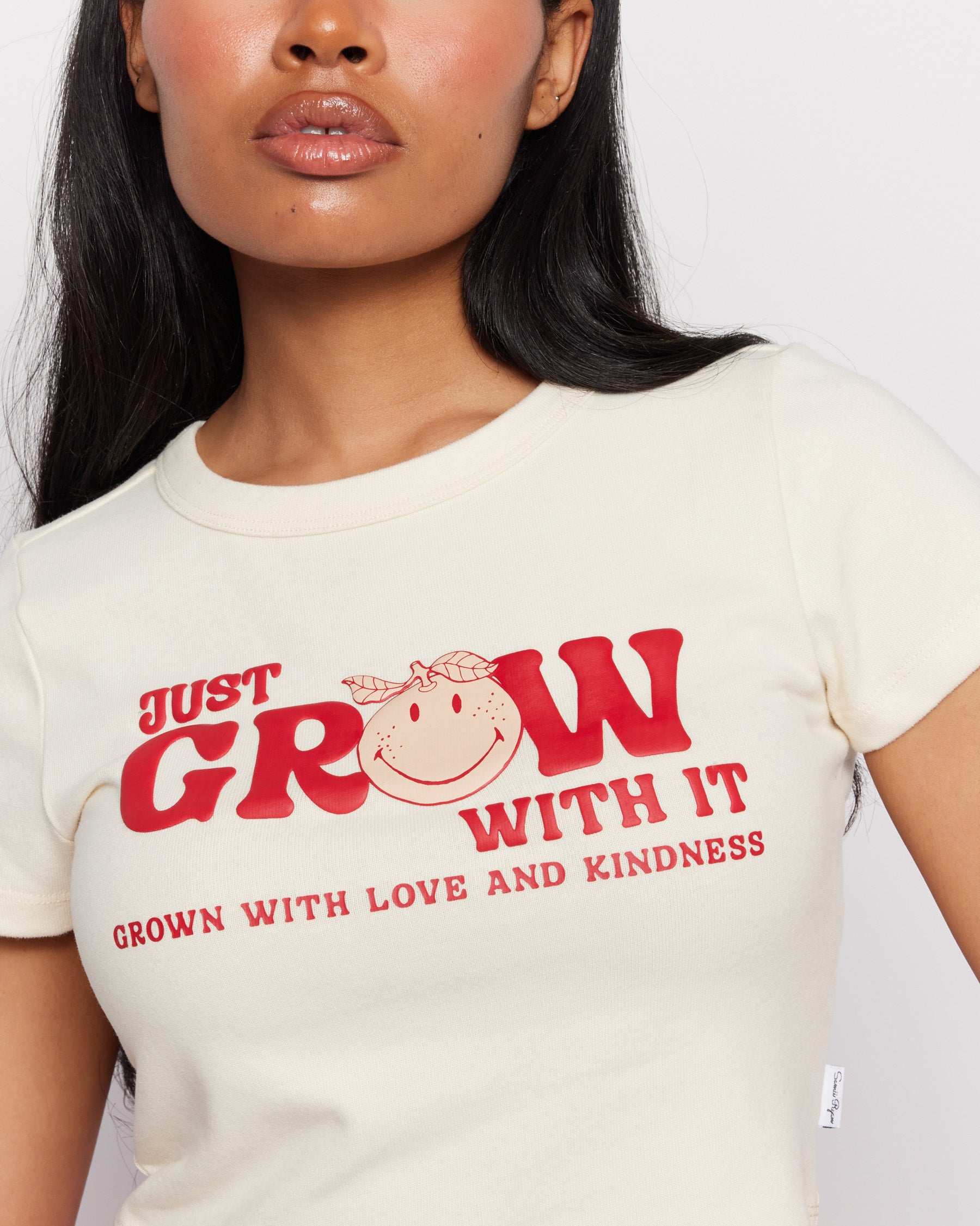 Samii Ryan x Smileyworld® Just Grow With It Baby Tee T-Shirt by Samii Ryan as seen on celebrities