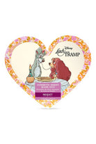 Heart-shaped cosmetic sheet mask packaging featuring Lady and the Tramp with floral border on a white background.