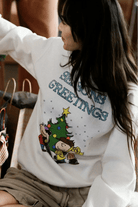 Shop Junk Food JUNKFOOD Peanuts Seasons Greetings Christmas Jumper Jumper for women – premium loungewear and festival fashion at Spoiled Brat