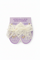 Pair of lace shoe charms on a purple card with 'Better With A Bow' text.