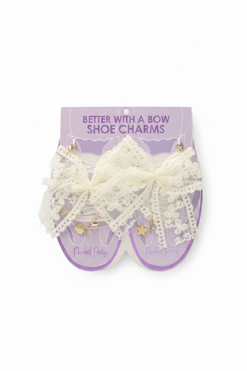 Pair of lace shoe charms on a purple card with 'Better With A Bow' text.