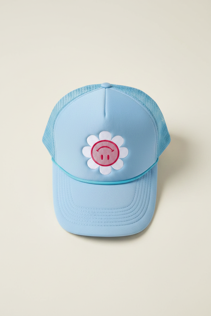 Light blue cap with a pink flower design on a beige background