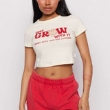 Shop Samii Ryan Samii Ryan x Smileyworld® Just Grow With It Baby Tee T-Shirt for women – premium loungewear and festival fashion at Spoiled Brat