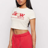 Shop Samii Ryan Samii Ryan x Smileyworld® Just Grow With It Baby Tee T-Shirt for women – premium loungewear and festival fashion at Spoiled Brat