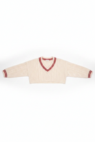 Cream-colored sweater with red trim on a white background