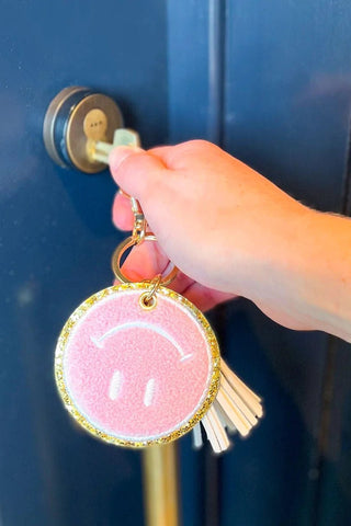 Packed Party Keep Cozy Smiley Keychain by Packed Party – Keyring – Pink | Spoiled Brat UK